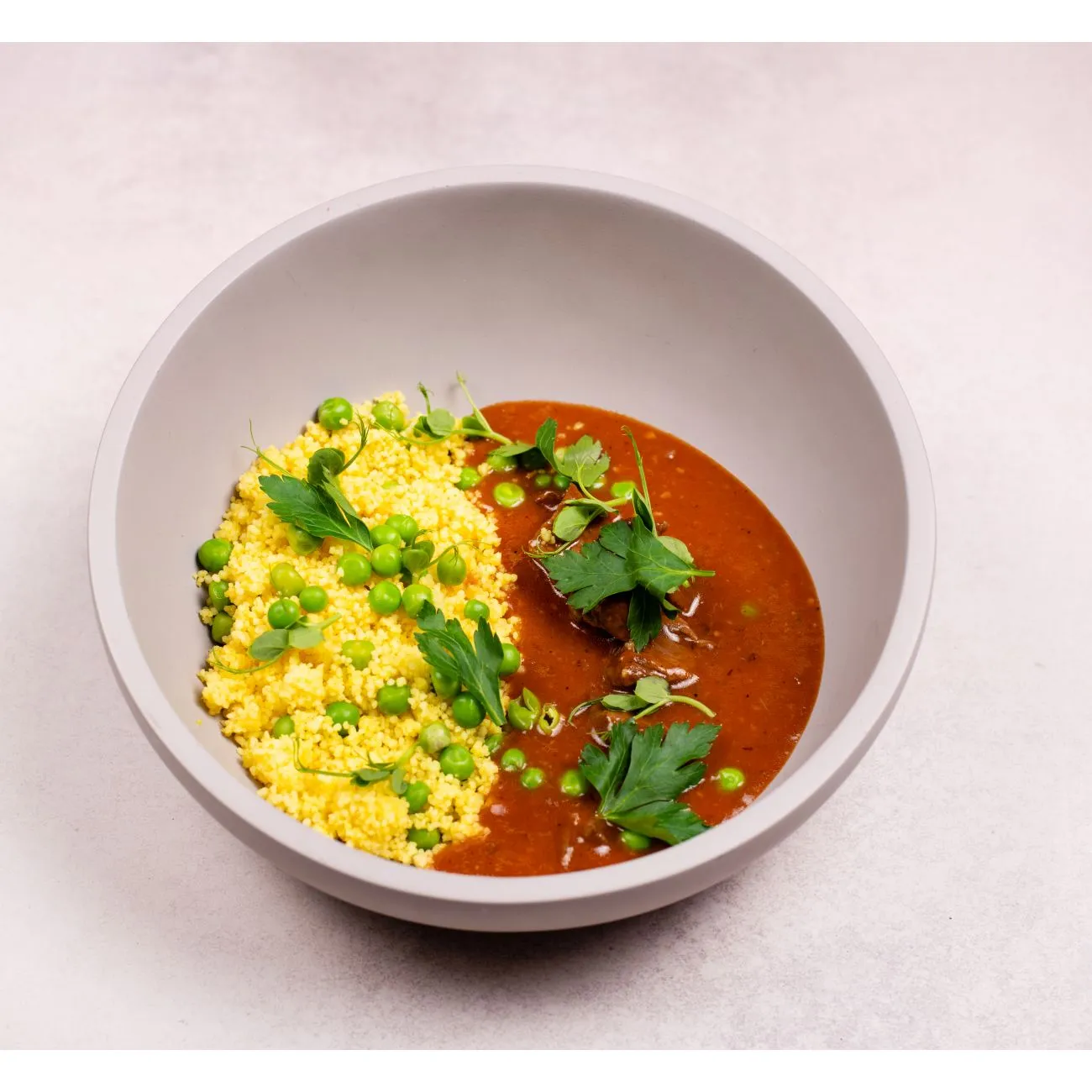 Beef tokan with peas and golden couscous