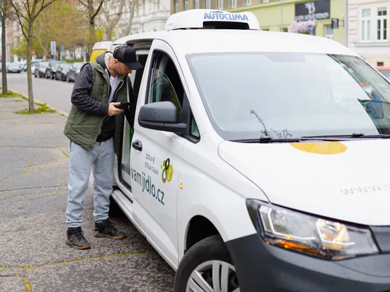 Driver loading meals into a refrigerated van